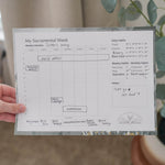 person holding filled out sacramental calendar