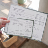 person holding large and small versions of my sacramental week calendar