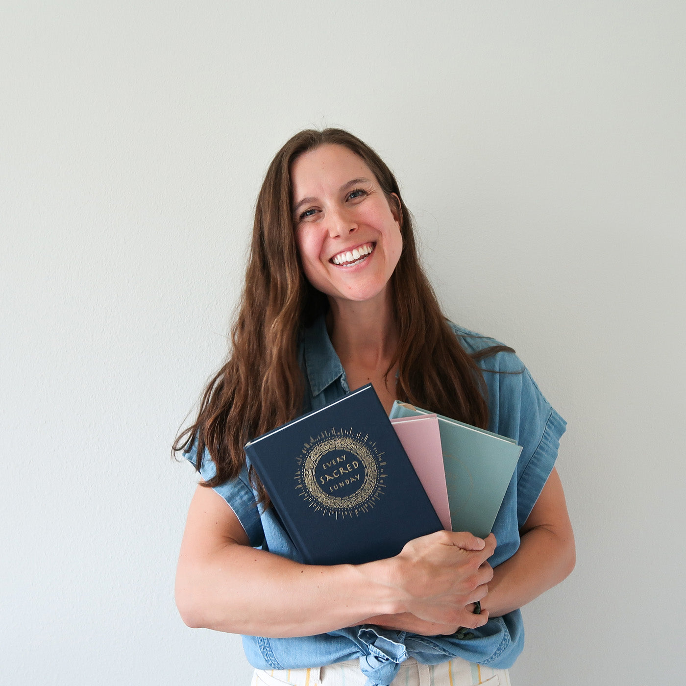photo of Kassie Manning holding mass journals